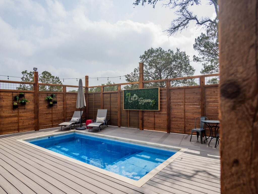 Private swimming pool on the fenced deck of an adults-only safari tent at Spoon Mountain Glamping in Wimberley, Texas