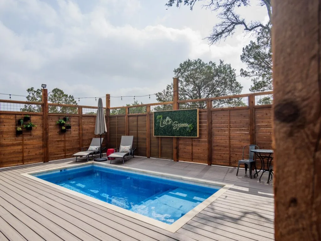 Private swimming pool on the fenced deck of an adults-only safari tent at Spoon Mountain Glamping in Wimberley, Texas