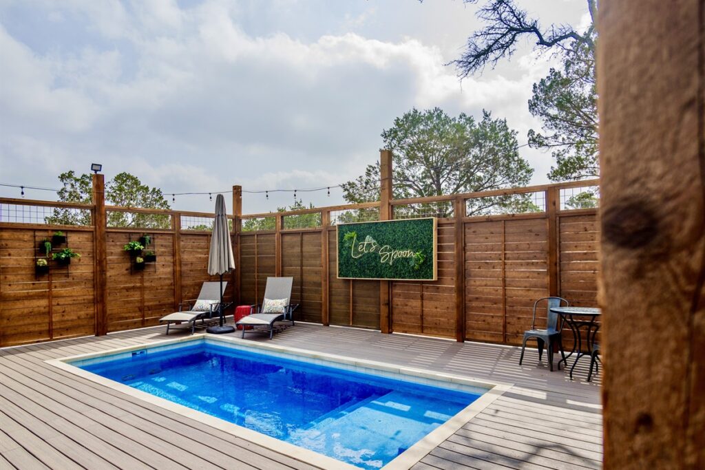 Private pool with the Let's Spoon sign on the deck of a safari tent at Spoon Mountain Glamping